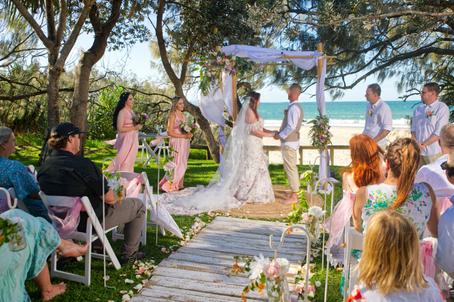beach wedding bamboo arbor with americana chairs